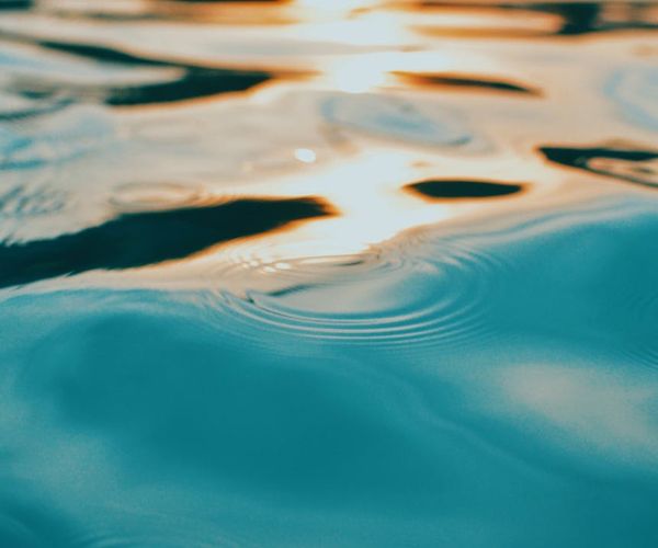 Abstract visual of light waves representing calm breathing patterns.